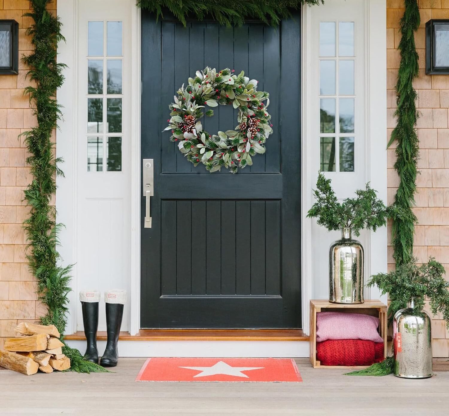 A vibrant wreath adorned with bold red berries and frosted greenery, providing a pop of color. It hangs on a bold-colored front door, creating a striking contrast perfect for winter decor || 5 Stunning Winter Door Wreaths That Aren’t Just for Christmas