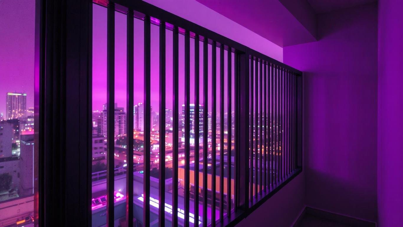 A contemporary balcony railing with evenly spaced vertical bars made of aluminum, painted in a sleek black finish. The setting is an urban apartment with a clean, minimalist aesthetic and city lights in the distance.