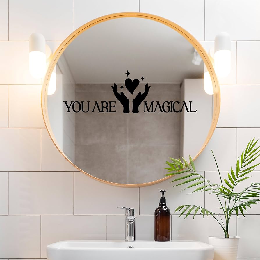 Inspirational calligraphy quote in a gold frame above a bathroom vanity